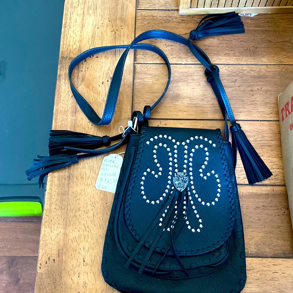 Black shoulder bag with studs and tassels